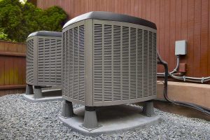 Two modern AC units installed outside a home