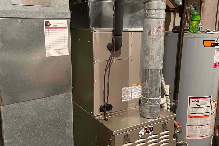 Home furnace system with ductwork and water heater in a basement
